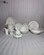 OneMore 61-piece premium super bone china dinner set for an 8-person serving, featuring elegant silver borders, displayed on a light wooden table against a minimalist neutral wall.