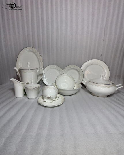 OneMore 61-piece premium super bone china dinner set for an 8-person serving, featuring elegant silver borders, displayed on a light wooden table against a minimalist neutral wall.