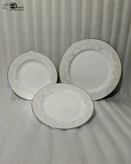 A stacked 18-piece OneMore super bone china dinnerware plate set featuring elegant cream plates with intricate lace damask borders, displayed on a dark wooden table with a silver runner and stainless steel cutlery