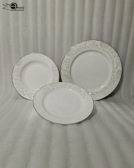 A professional shot of an 18-piece super bone china plate set stacked in three tiers, featuring elegant gold rims and subtle beige floral patterns on a luxury wooden dining table with a linen runner.