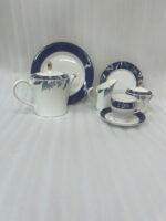 A 24-piece luxury tea set featuring white porcelain with deep blue floral patterns and gold-rimmed accents, including a teapot, cups, saucers, and plates.
