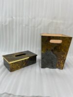 Modern gold and grey textured office dustbin with a matching rectangular tissue box on a premium wooden executive desk.