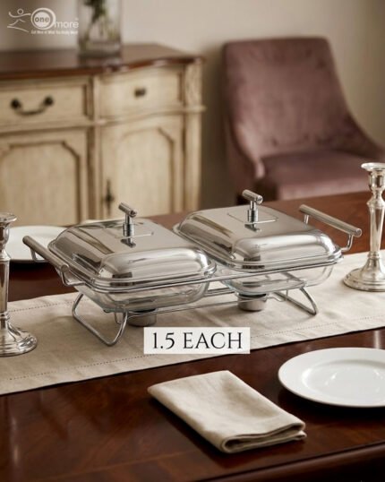 Paramount Series dual stainless steel food warmer with two 1.5-liter glass buffet dishes and polished lids, featuring two buffet burners underneath on a decorated dining table.