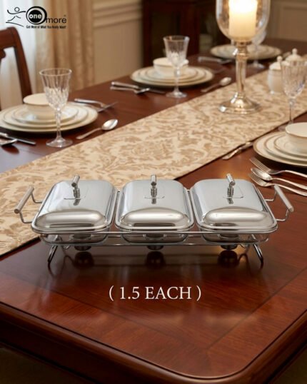Paramount Series 3-in-1 stainless steel food warmer with three 1.5L glass dishes and buffet burners set on a formal wooden dining table.