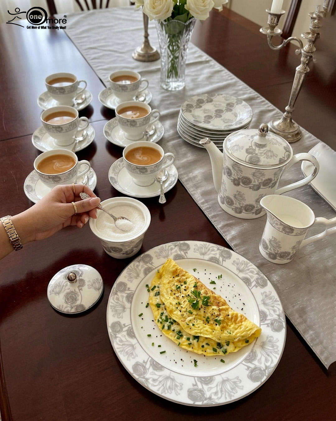 1 A luxury super bone china teacup and saucer set featuring a grey floral rose pattern, shown on a formal wooden dining table with a matching teapot and breakfast setting.