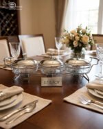 A Paramount Series 3-in-1 stainless steel food warmer buffet server with three 1.5L glass dishes and polished metal lids, featuring integrated buffet burner holders on a set dining table.