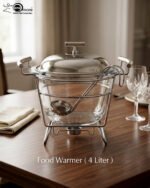 Paramount Series 4-liter glass food warmer with a stainless steel stand, lid, and ladle, featuring a buffet burner holder on a wooden dining table.v