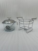 Paramount Series 4-liter glass food warmer with a stainless steel stand, lid, and ladle, featuring a buffet burner holder on a wooden dining table.