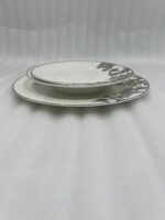 A stack of 18 premium super bone china plates featuring an elegant brown floral pattern on a wooden table, including rice, deep, and quarter plates.