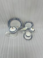 Elevate your hosting experience with this exquisite 24-piece luxury tea set, designed to bring sophisticated elegance to any table. Crafted from high-quality, durable porcelain, this collection features a timeless white finish adorned with a striking blue marble design and delicate gold-rimmed detailing. Perfect for afternoon tea, formal gatherings, or gifting, this comprehensive set provides everything needed for a seamless service. Key Features: Premium Aesthetic: Features a modern blue marble pattern paired with luxurious gold accents. Complete 24-Piece Set: Includes everything required for elegant serving. High-Quality Material: Durable, heat-resistant porcelain suitable for everyday use or special occasions. Set Composition: 1 Dinner Plate 6 Quarter Plates 6 Tea Cups and 6 Saucers 1 Teapot with Lid 1 Sugar Pot with Lid 1 Milk Pot