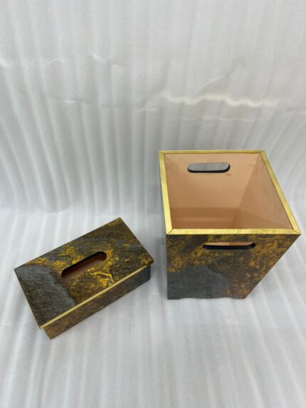 Modern gold and grey textured office dustbin with a matching rectangular tissue box on a premium wooden executive desk.