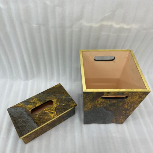 Modern gold and grey textured office dustbin with a matching rectangular tissue box on a premium wooden executive desk.
