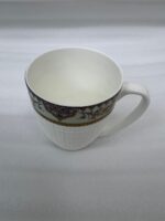 Enjoy the perfect blend of elegance and comfort with this premium bone china mug set. Featuring an intricate, vintage-inspired filigree border in deep purple and gold tones, these mugs bring a touch of royalty to your daily tea or coffee rituals. The lower half of the mug boasts a sophisticated textured grid pattern, providing a modern tactile feel and a secure grip. Crafted for those who appreciate fine craftsmanship, this set is ideal for cozy rainy mornings on the balcony or hosting guests with style. Key Features Premium Bone China: Lightweight yet durable with a smooth, translucent finish. Intricate Artistry: Beautifully detailed ethnic motifs and gold accents for a luxury aesthetic. Ergonomic Design: Large, comfortable handle and a textured body for an enhanced grip. Versatile Use: Perfect for hot tea, coffee, lattes, or hot chocolate. Capacity: Standard size, ideal for a generous serving of your favorite beverage
