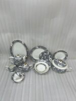 A luxury super bone china dinner set featuring grey floral patterns and gold-tipped lids, displayed on a dark wooden table in "3.jpg"