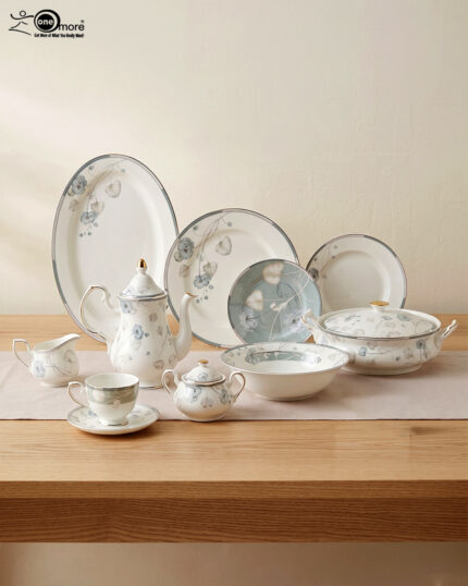 A complete super bone china dinner set featuring delicate blue and grey floral patterns with silver rims, arranged on a wooden table.