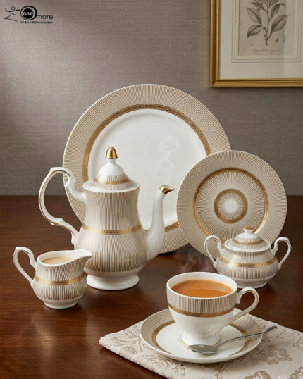 A premium super bone china tea set featuring a teapot, teacup and saucer, creamer, and sugar bowl with elegant beige striped patterns and luxury gold accents on a wooden table.