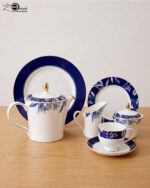 A 24-piece luxury tea set featuring white porcelain with deep blue floral patterns and gold-rimmed accents, including a teapot, cups, saucers, and plates.