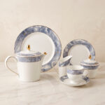 Elevate your hosting experience with this exquisite 24-piece luxury tea set, designed to bring sophisticated elegance to any table. Crafted from high-quality, durable porcelain, this collection features a timeless white finish adorned with a striking blue marble design and delicate gold-rimmed detailing. Perfect for afternoon tea, formal gatherings, or gifting, this comprehensive set provides everything needed for a seamless service. Key Features: Premium Aesthetic: Features a modern blue marble pattern paired with luxurious gold accents. Complete 24-Piece Set: Includes everything required for elegant serving. High-Quality Material: Durable, heat-resistant porcelain suitable for everyday use or special occasions. Set Composition: 1 Dinner Plate 6 Quarter Plates 6 Tea Cups and 6 Saucers 1 Teapot with Lid 1 Sugar Pot with Lid 1 Milk Pot