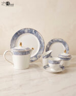 Elevate your hosting experience with this exquisite 24-piece luxury tea set, designed to bring sophisticated elegance to any table. Crafted from high-quality, durable porcelain, this collection features a timeless white finish adorned with a striking blue marble design and delicate gold-rimmed detailing. Perfect for afternoon tea, formal gatherings, or gifting, this comprehensive set provides everything needed for a seamless service. Key Features: Premium Aesthetic: Features a modern blue marble pattern paired with luxurious gold accents. Complete 24-Piece Set: Includes everything required for elegant serving. High-Quality Material: Durable, heat-resistant porcelain suitable for everyday use or special occasions. Set Composition: 1 Dinner Plate 6 Quarter Plates 6 Tea Cups and 6 Saucers 1 Teapot with Lid 1 Sugar Pot with Lid 1 Milk Pot