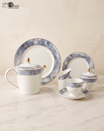 Elevate your hosting experience with this exquisite 24-piece luxury tea set, designed to bring sophisticated elegance to any table. Crafted from high-quality, durable porcelain, this collection features a timeless white finish adorned with a striking blue marble design and delicate gold-rimmed detailing. Perfect for afternoon tea, formal gatherings, or gifting, this comprehensive set provides everything needed for a seamless service. Key Features: Premium Aesthetic: Features a modern blue marble pattern paired with luxurious gold accents. Complete 24-Piece Set: Includes everything required for elegant serving. High-Quality Material: Durable, heat-resistant porcelain suitable for everyday use or special occasions. Set Composition: 1 Dinner Plate 6 Quarter Plates 6 Tea Cups and 6 Saucers 1 Teapot with Lid 1 Sugar Pot with Lid 1 Milk Pot