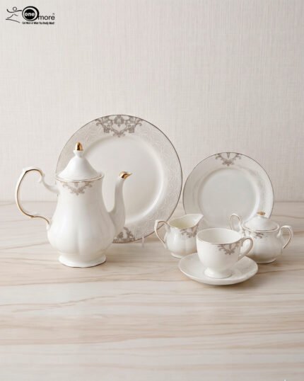 A luxurious 24-piece white porcelain tea set featuring delicate gold filigree patterns, including a teapot, teacups, saucers, plates, and serving pieces displayed on a marble-textured surface
