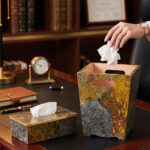 Modern gold and grey textured office dustbin with a matching rectangular tissue box on a premium wooden executive desk.