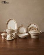 A premium 61-piece Super Bone dinner set by OneMore Crockery featuring cream-colored plates with gold-rimmed textured borders, including a teapot, cups, serving bowls, and platters arranged on a dark wooden table