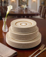 A luxury super bone china dinner set featuring a white base with gold-toned textured borders and metallic accents, displayed on a wooden table in 7.jpg.
