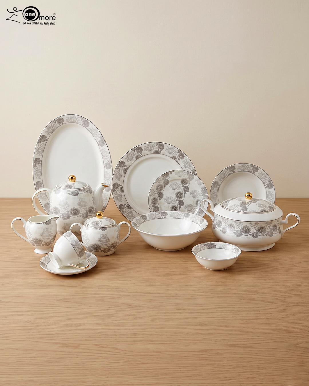 3 A complete white Super Bone dinner set featuring grey floral patterns and gold accents, including plates, bowls, a teapot, and serving dishes, displayed on a wooden surface in 3.jpg.