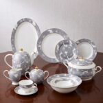 A luxury super bone china dinner set featuring grey floral patterns and gold-tipped lids, displayed on a dark wooden table in "3.jpg"