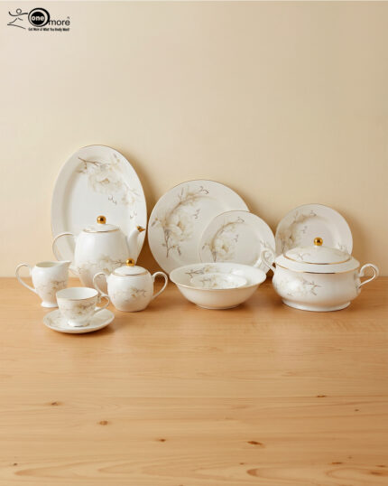 Luxury Super Bone China dinnerware set featuring a delicate white floral pattern, gold-rimmed edges, and matching tea service pieces on a wooden surface