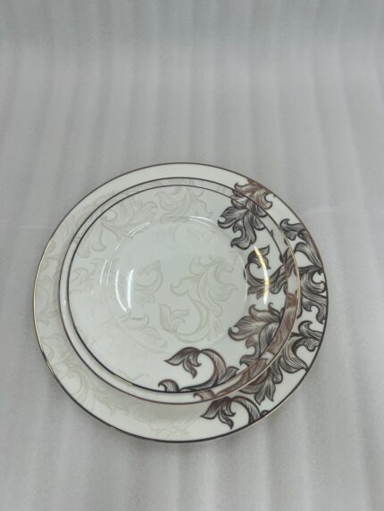A stack of 18 premium super bone china plates featuring an elegant brown floral pattern on a wooden table, including rice, deep, and quarter plates.