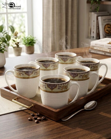 Enjoy the perfect blend of elegance and comfort with this premium bone china mug set. Featuring an intricate, vintage-inspired filigree border in deep purple and gold tones, these mugs bring a touch of royalty to your daily tea or coffee rituals. The lower half of the mug boasts a sophisticated textured grid pattern, providing a modern tactile feel and a secure grip. Crafted for those who appreciate fine craftsmanship, this set is ideal for cozy rainy mornings on the balcony or hosting guests with style. Key Features Premium Bone China: Lightweight yet durable with a smooth, translucent finish. Intricate Artistry: Beautifully detailed ethnic motifs and gold accents for a luxury aesthetic. Ergonomic Design: Large, comfortable handle and a textured body for an enhanced grip. Versatile Use: Perfect for hot tea, coffee, lattes, or hot chocolate. Capacity: Standard size, ideal for a generous serving of your favorite beverage