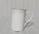 A 6-piece set of white bone china mugs as shown in 3.jpg, featuring a grey marble pattern near the rim and gold trim, displayed on a wooden desk next to books and gold spoons.