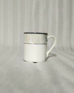 A 6-piece set of white bone china mugs as shown in 3.jpg, featuring a grey marble pattern near the rim and gold trim, displayed on a wooden desk next to books and gold spoons.