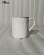 A set of elegant white bone china mugs featuring a subtle beige floral scroll pattern near the silver-trimmed rim, shown in both a standard short version in 4.jpg and a taller long version in 5.jpg