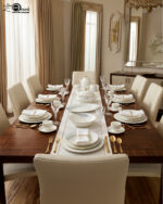 A luxurious white Super Bone China dinner set featuring delicate grey leaf patterns and gold-rimmed detailing, including plates, bowls, a teapot, and a tureen.