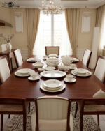 A complete super bone china dinner set in file 3.jpg featuring a delicate blue rose pattern, gold-rimmed edges, and including a teapot, plates, bowls, and serving dishes on a marble surface.