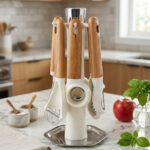 A 7-piece kitchen gadget set featuring cream-colored heads and ergonomic wooden handles, displayed both individually and hanging on a matching rotating stand on a marble countertop.