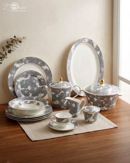 61-piece luxury Super Bone China dinnerware set with grey floral patterns and gold accents, including plates, tea pot, and serving bowls on a wooden table