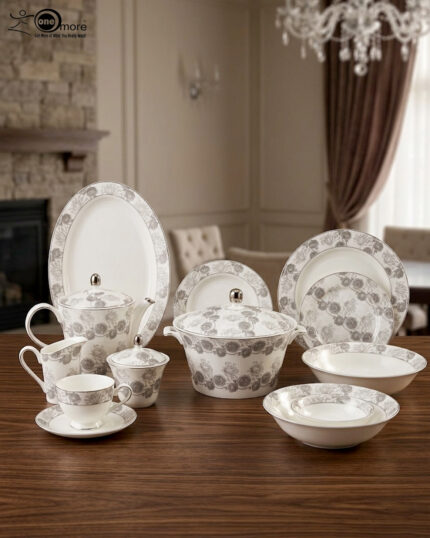 Elegant 61-piece white Super Bone China dinner set with grey floral patterns, including plates, bowls, a teapot, and a lidded casserole dish, displayed on a wooden table.
