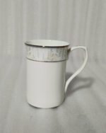 A 6-piece set of white bone china mugs as shown in 3.jpg, featuring a grey marble pattern near the rim and gold trim, displayed on a wooden desk next to books and gold spoons.
