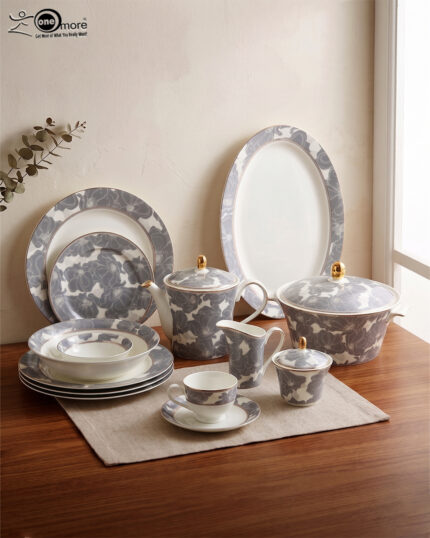 61-piece luxury Super Bone China dinnerware set with grey floral patterns and gold accents, including plates, tea pot, and serving bowls on a wooden table