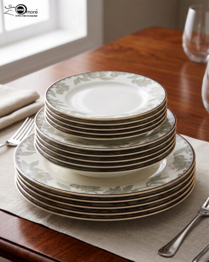 Stacked 18-piece super bone china plate set with elegant green floral patterns and gold rims on a wooden dining table setting.