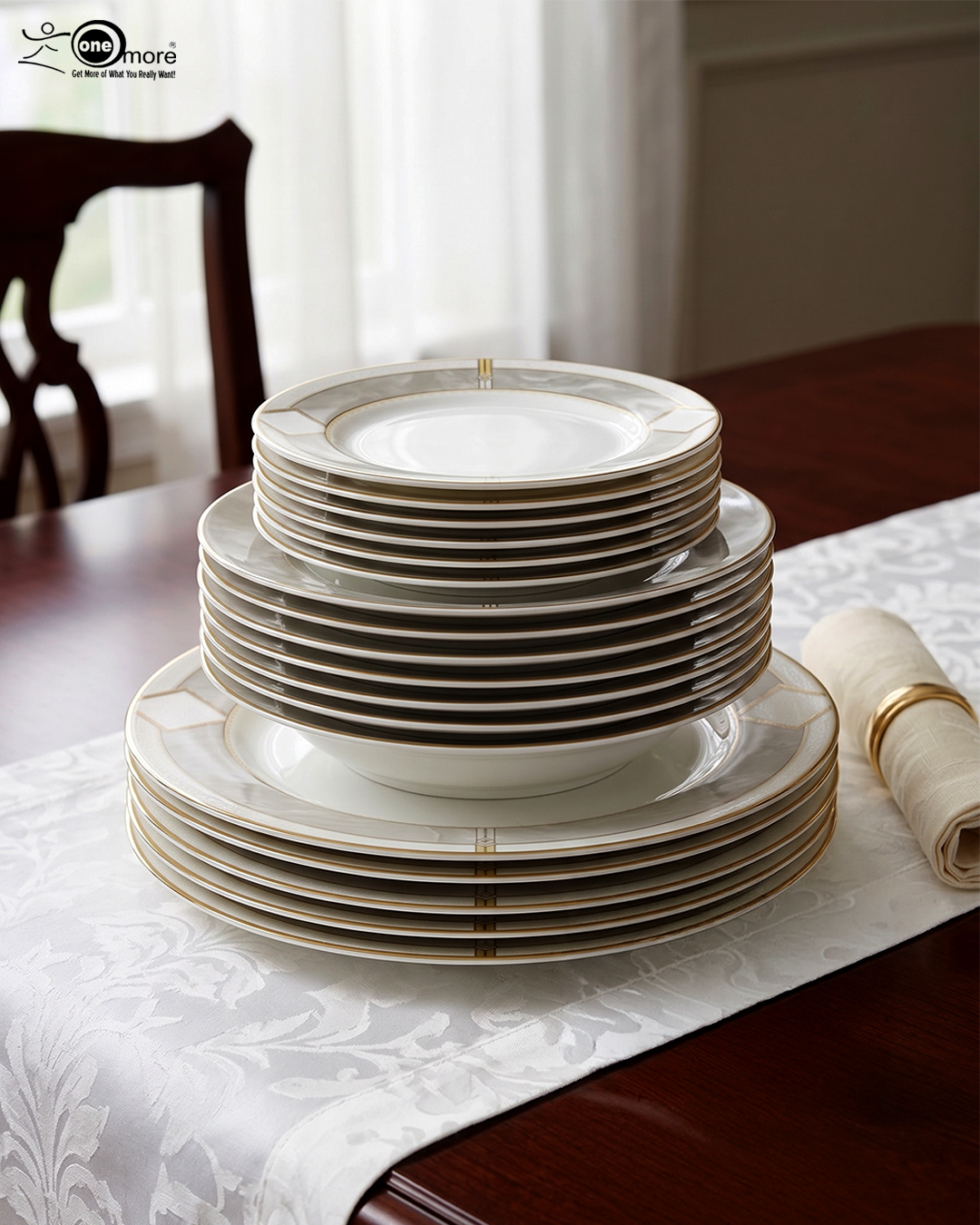 5 A stacked 18-piece super bone china dinner plate set featuring a white porcelain body with an elegant gold geometric border pattern, neatly arranged on a white damask table runner over a dark wooden dining table next to a rolled napkin with a gold ring.