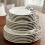A stack of 18 premium super bone china plates featuring an elegant brown floral pattern on a wooden table, including rice, deep, and quarter plates.