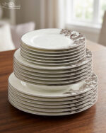 A stack of 18 premium super bone china plates featuring an elegant brown floral pattern on a wooden table, including rice, deep, and quarter plates.