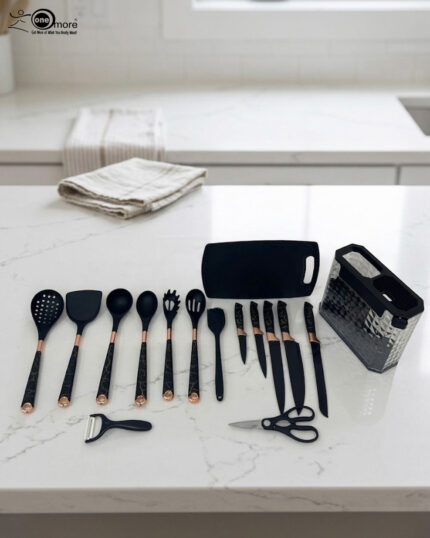 A comprehensive 17-piece kitchen tool set featuring black and rose gold silicone utensils, a matching knife set with marble-patterned handles, a vegetable peeler, kitchen shears, and a black cutting board, all stored in a clear geometric textured organizer.