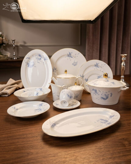 A luxury 61-piece Super Bone China dinner set by Onemore Crockery, elegantly arranged for an 8-person serving on a dark wooden dining table with a floral pattern and gold accents