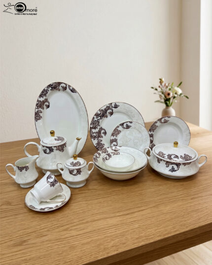 A luxury super bone china dinner set featuring a white base and intricate brown acanthus leaf patterns, including plates, bowls, a teapot, and serving dishes on a wooden table.